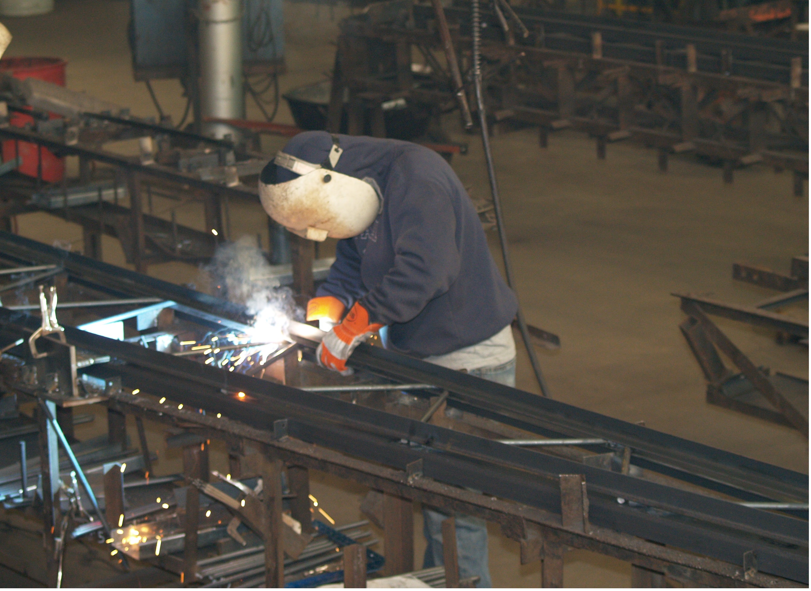 a worker welding a steel truss